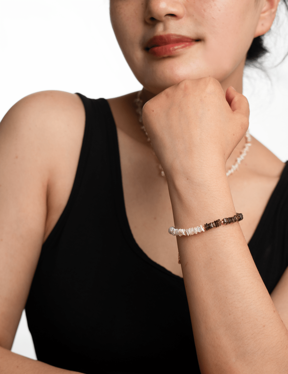 AURA DUO Smoky Quartz Pearl Bracelet worn on a woman's wrist, showcasing its elegant design and natural stones.