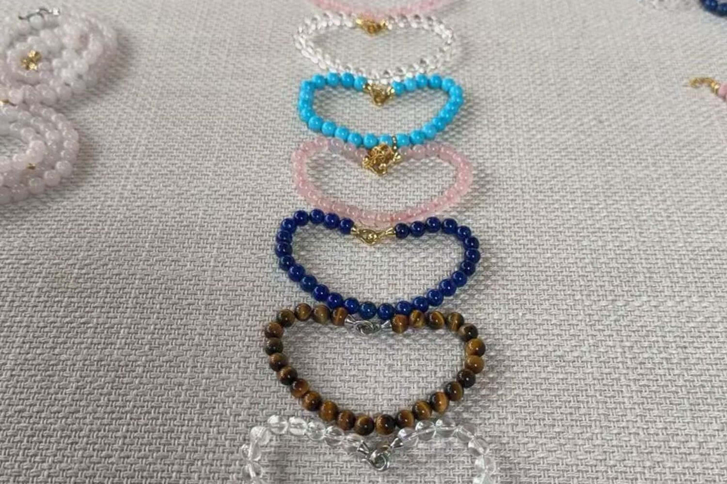 Colorful heart-shaped bead bracelets in various stones, perfect for Valentine's Day gifts.