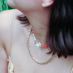 MIRA choker necklace featuring orange opal, clear quartz, and mother of pearl, worn elegantly by a model.