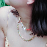 MIRA choker necklace featuring orange opal, clear quartz, and mother of pearl, worn elegantly by a model.