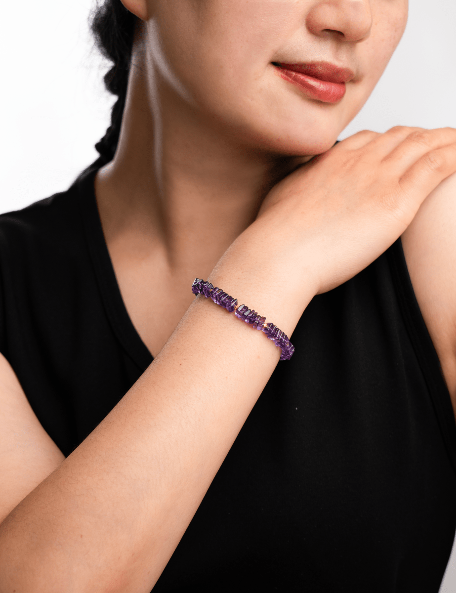 Model wearing an amethyst faceted bracelet showcasing 6mm beads, exuding elegance and spiritual energy.