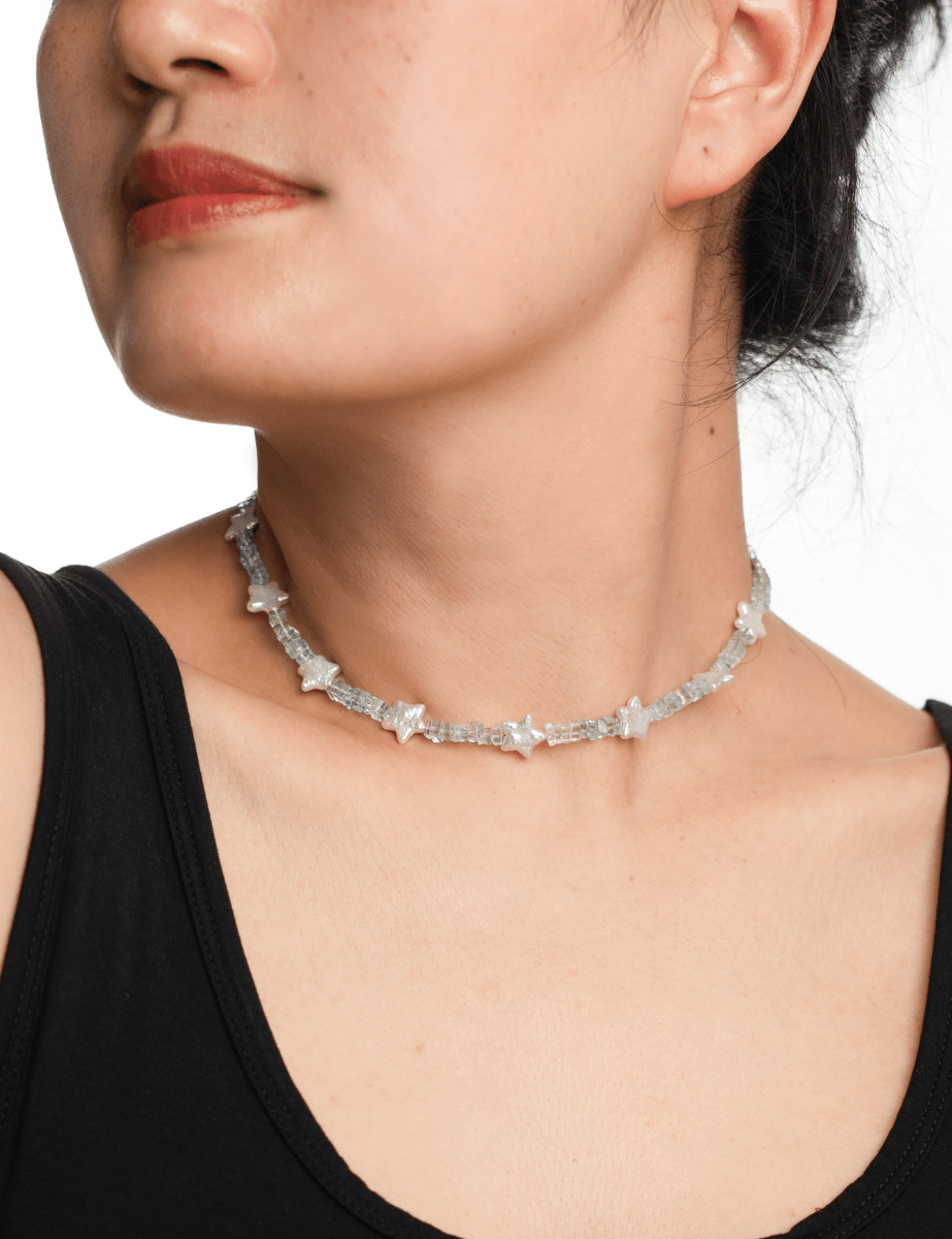 Model wearing AURA DUO Aquamarine Star Pearl Necklace featuring aquamarine beads and star-shaped pearls.