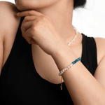 Woman wearing AURA DUO Blue Apatite Pearl Bracelet showcasing its elegant design and vibrant colors.