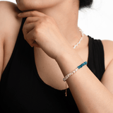 Woman wearing AURA DUO Blue Apatite Pearl Bracelet showcasing its elegant design and vibrant colors.