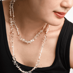 Woman wearing AURA DUO Clear Quartz Pearl Necklace, showcasing its elegant layers and natural beauty.