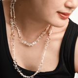 Woman wearing AURA DUO Clear Quartz Pearl Necklace, showcasing its elegant layers and natural beauty.