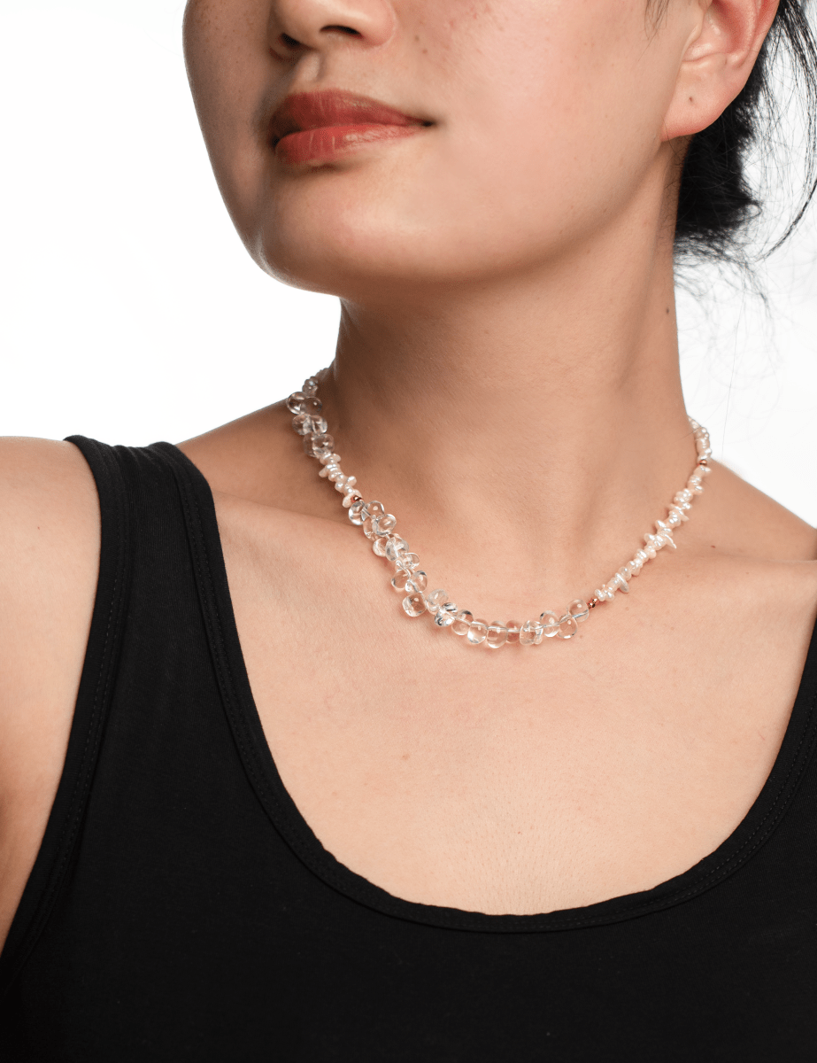 Model showcasing the AURA DUO Clear Quartz Pearl Necklace, highlighting its crystal elegance and minimalist design.