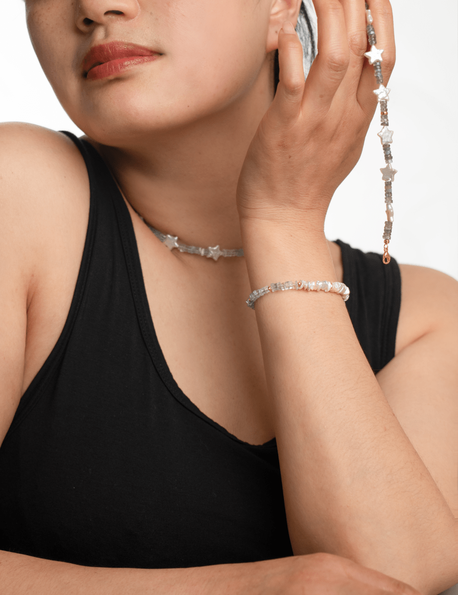 Woman wearing AURA DUO Gray Moonstone Star Pearl bracelet and matching necklace, showcasing celestial elegance and natural charm.