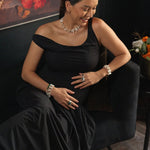 Woman in an elegant black dress modeling a Biwa-style stick pearl necklace, showcasing refined jewelry style.