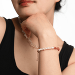 AURA DUO Sunstone Pearl Bracelet showcased on a model's wrist, featuring sunstone and pearls with spacer beads.