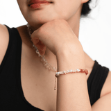 AURA DUO Sunstone Pearl Bracelet showcased on a model's wrist, featuring sunstone and pearls with spacer beads.