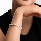 Close-up of a model wearing a crystal bracelet, showcasing elegance and style against a neutral background.