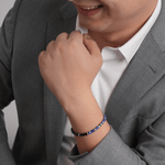 Man wearing a Lapis Lazuli and Black Onyx bracelet with sterling silver, showcasing style and elegance.