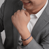 Man wearing a Lapis Lazuli and Black Onyx bracelet with sterling silver, showcasing style and elegance.
