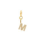 Gold letter charm 'M' adorned with sparkling zircon stones, perfect for personal expression and individuality.