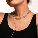Close-up of a woman wearing a colorful Rainbow Sapphire dainty necklace, showcasing vibrant hues and elegant design.