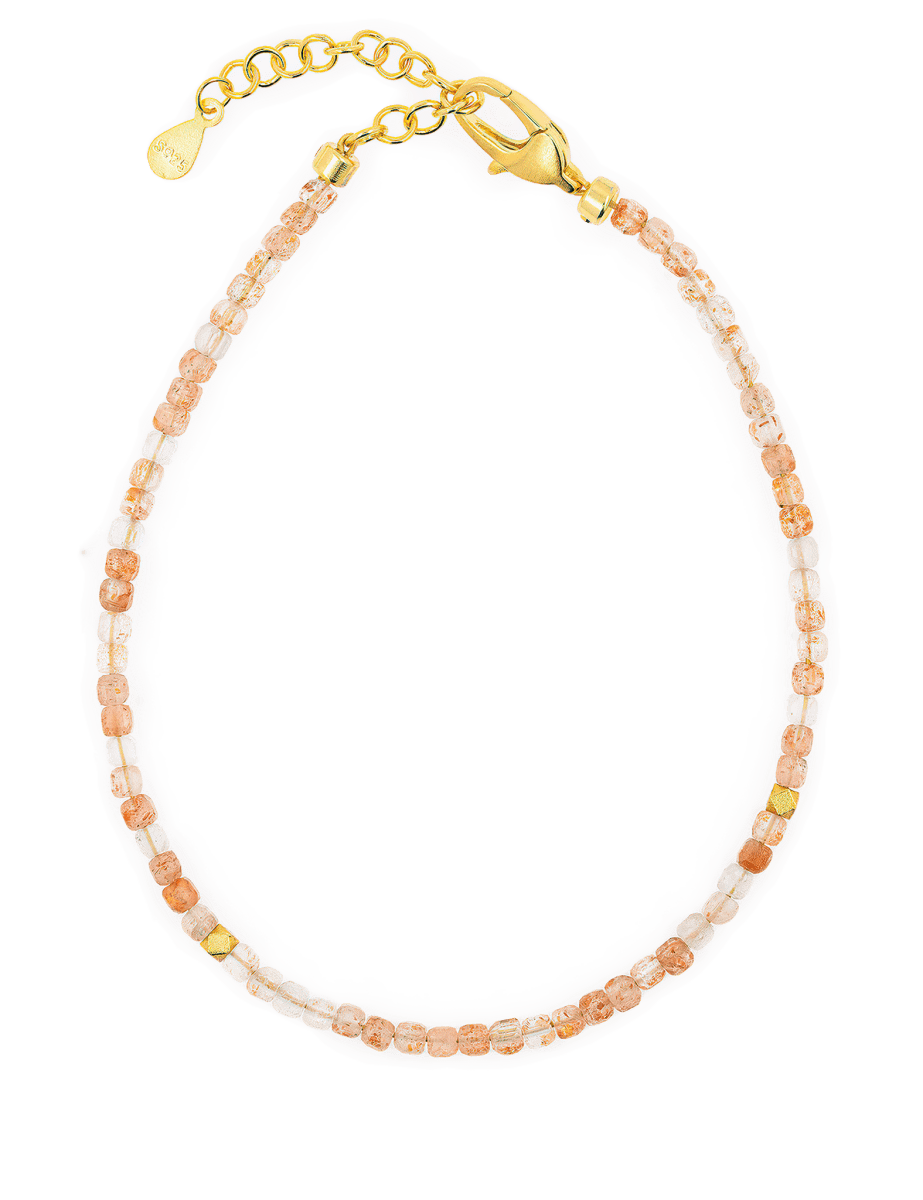 Dainty Sunstone bracelet with silver spacer beads, featuring a gold clasp and adjustable chain for a perfect fit.