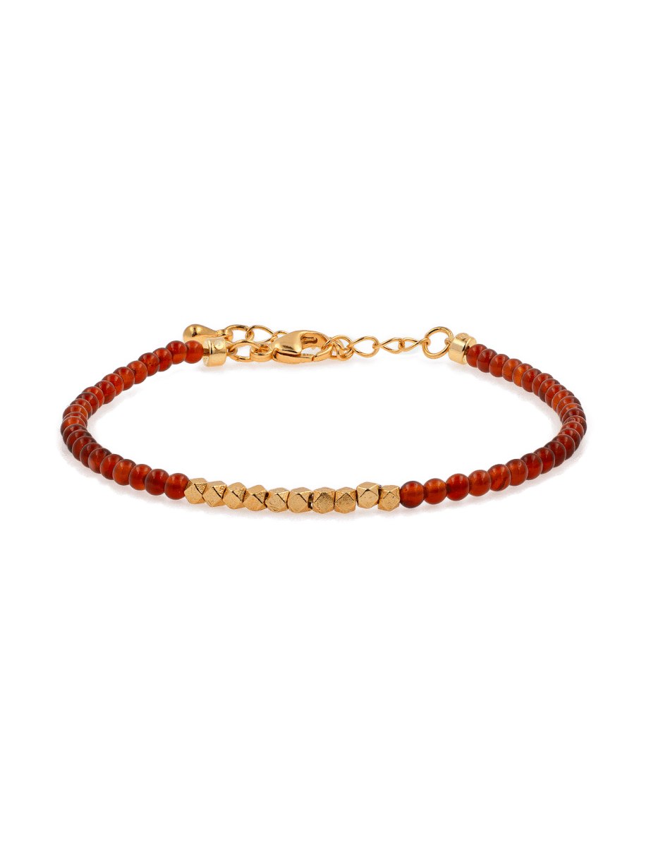 Dainty Fire Ember Core Red Onyx bracelet with gold spacer beads, symbolizing passion and inner strength.