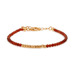 Dainty Fire Ember Core Red Onyx bracelet with gold spacer beads, symbolizing passion and inner strength.