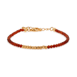 Dainty Fire Ember Core Red Onyx bracelet with gold spacer beads, symbolizing passion and inner strength.