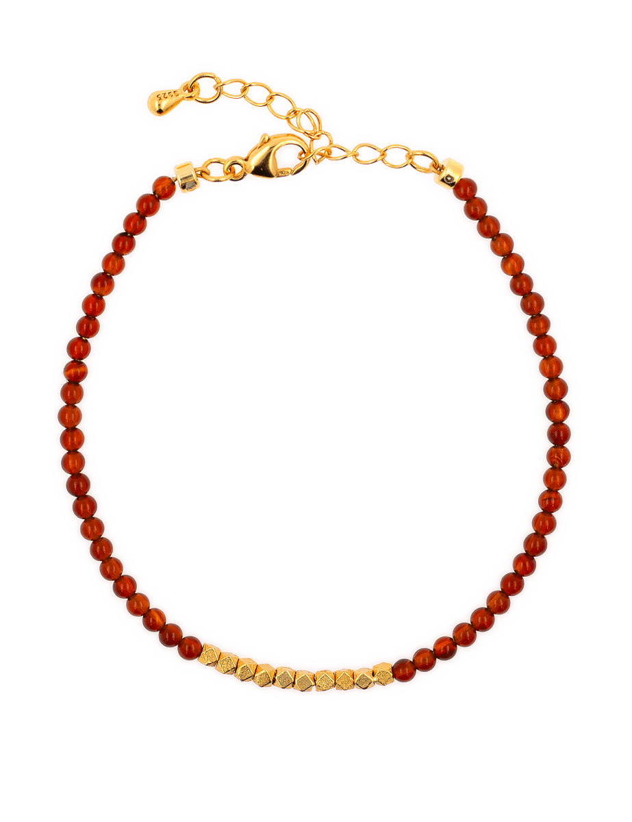 Dainty Fire Ember Core Red Onyx bracelet with 2mm spacer beads and gold clasp, symbolizing passion and vitality.