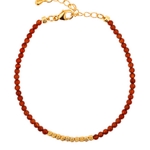 Dainty Fire Ember Core Red Onyx bracelet with 2mm spacer beads and gold clasp, symbolizing passion and vitality.