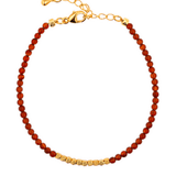 Dainty Fire Ember Core Red Onyx bracelet with 2mm spacer beads and gold clasp, symbolizing passion and vitality.