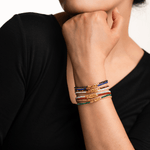 Model showcasing layered dainty bracelets, highlighting vibrant colors and intricate spacer beads.