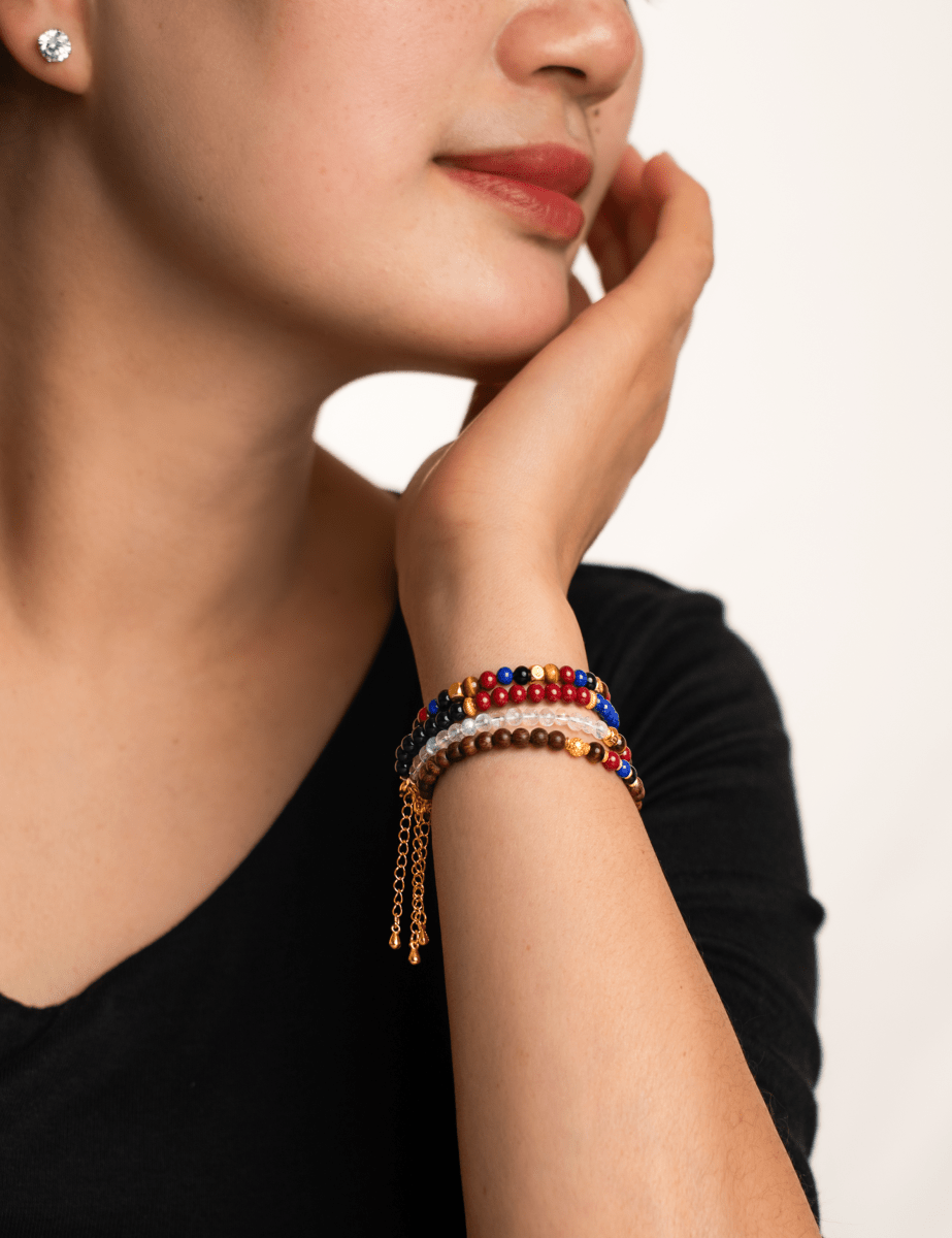 Model wearing BEAMMORE Zenith Pulse faceted black onyx, cinnabar & lapis lazuli beaded bracelet with spacer beads – Elegant jewelry gift for women