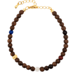 Five Elements Stellar Guardian Bracelet featuring wooden beads and Lapis Lazuli, Black Onyx, and Cinnabar accents.