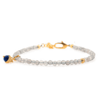Dainty Gray Moonstone bracelet with silver spacer beads and Lapis Lazuli charm, promoting emotional balance and intuition.
