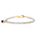 Dainty Gray Moonstone bracelet with silver spacer beads and Lapis Lazuli charm, promoting emotional balance and intuition.