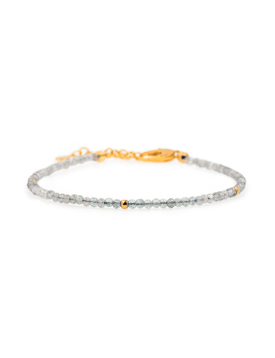 Dainty gray moonstone bracelet with silver spacer beads and gold accent, perfect for spiritual growth and elegance.