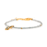 Gray Moonstone dainty bracelet with silver spacer beads and Tourmaline charm, symbolizing emotional healing and intuition.