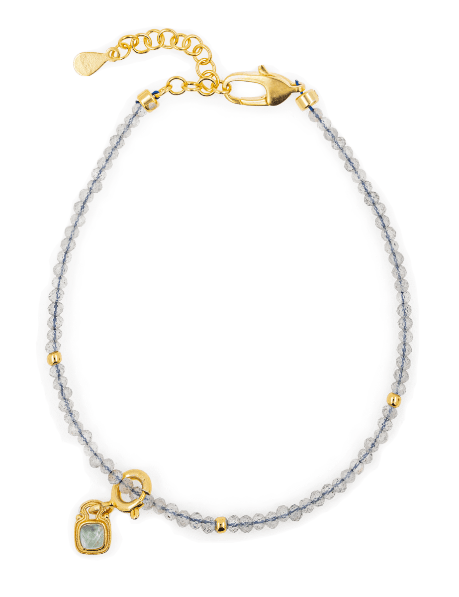 Growth Gray Moonstone bracelet with silver spacer beads and Tourmaline charm, symbolizing emotional healing and balance.