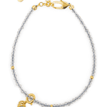 Growth Gray Moonstone bracelet with silver spacer beads and Tourmaline charm, symbolizing emotional healing and balance.