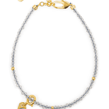 Growth Gray Moonstone bracelet with silver spacer beads and Tourmaline charm, symbolizing emotional healing and balance.