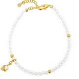 Elegant clear beaded bracelet with gold accents and charm for a chic look.