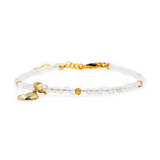 Dainty Moonstone bracelet with silver spacer bead and moon charm for emotional healing and intuition enhancement.