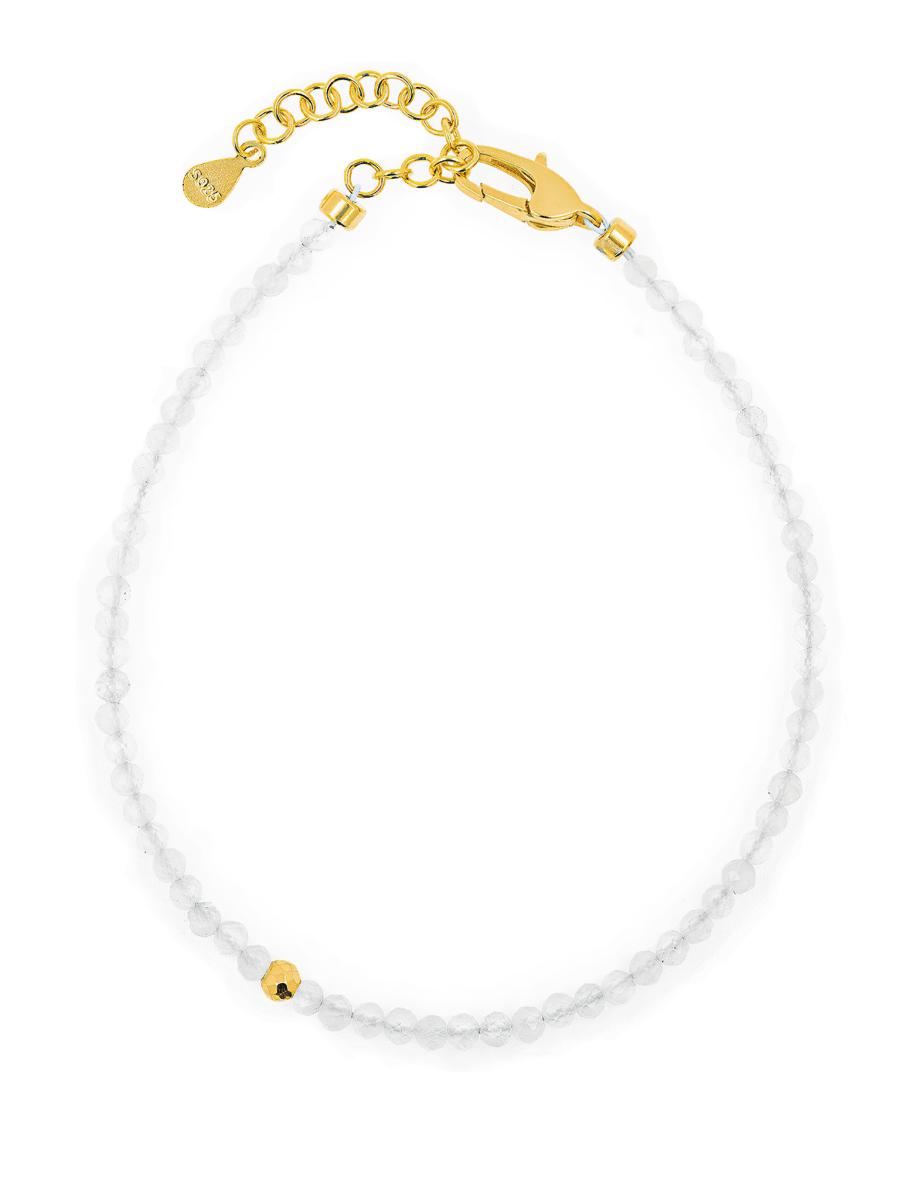 Dainty white crystal bracelet with gold clasp and bead for elegant style and personal growth.