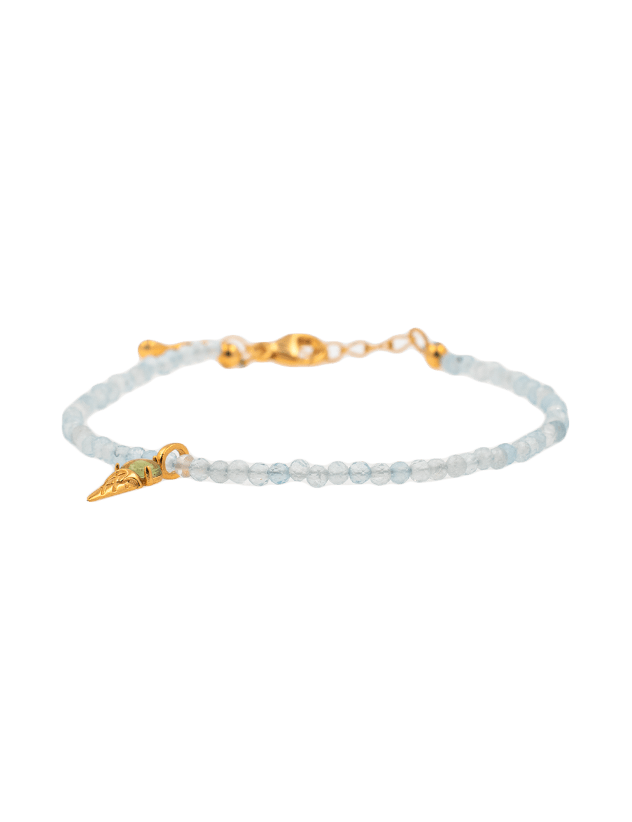 Health Aquamarine faceted bracelet with gold clasp and ice cream charm, symbolizing tranquility and joy.