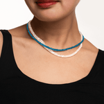 Woman wearing a dainty Blue Apatite necklace with 3mm faceted beads, showcasing strength and energy enhancement.