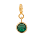 Green zircon charm in gold setting, promoting health and vitality, perfect for Taurus and enhancing well-being.