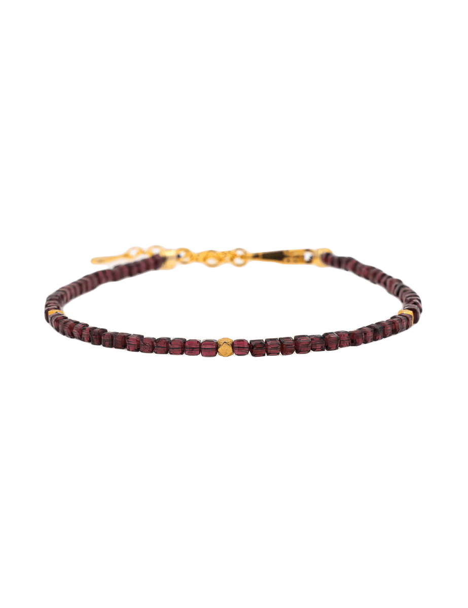 Dainty garnet bracelet with gold spacer beads, symbolizing love and emotional healing.