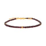 Dainty garnet bracelet with gold spacer beads, symbolizing love and emotional healing.