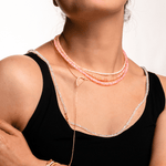 Model wearing a Love Pink Opal Faceted Necklace showcasing its dainty design and soft rosy glow.