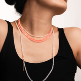 Woman wearing a Love Pink Opal Faceted Dainty Necklace showcasing its soft, rosy glow.