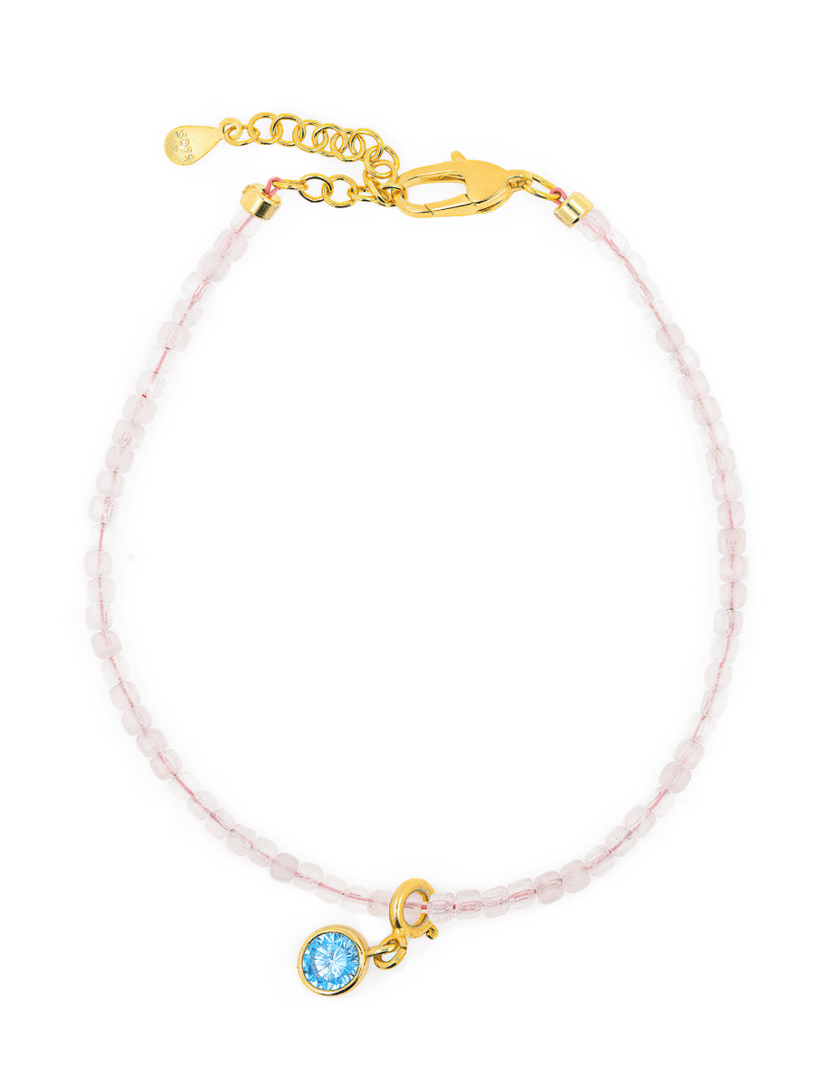 Rose Quartz faceted bracelet with Blue Zircon charm and gold clasp for emotional harmony and self-love.
