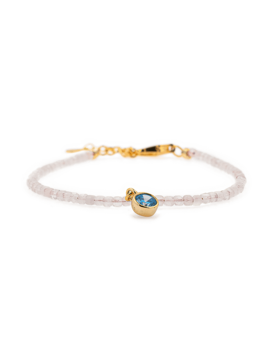 Rose Quartz faceted bracelet with Blue Zircon charm, 925 sterling silver clasp, promoting love and emotional balance.