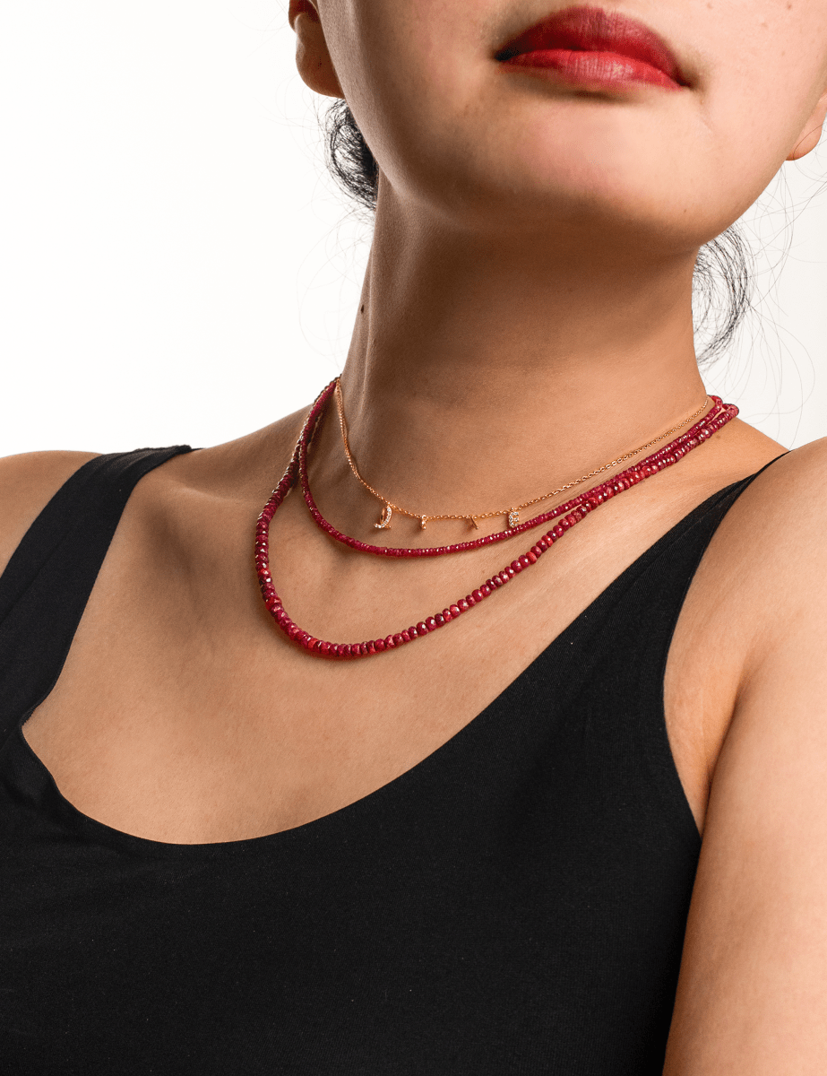 Model showcasing the Love Ruby Faceted Dainty Necklace, highlighting its vibrant red hues and elegant design.